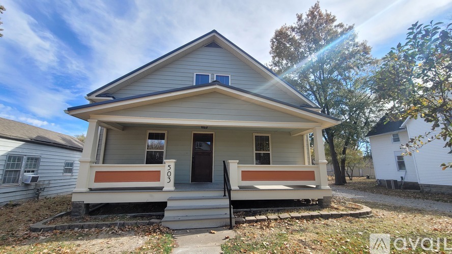 A house with a porch and a front yard.