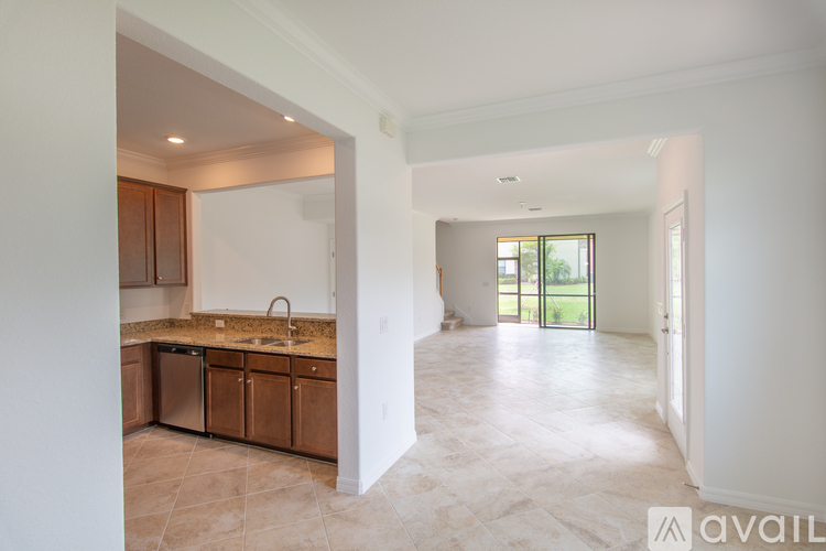 A kitchen with brown cabinets and a marble countertop.