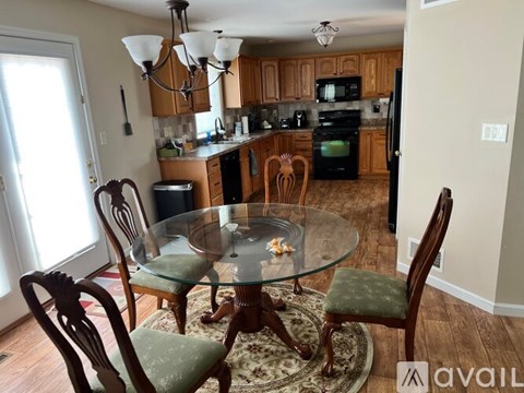 A kitchen with a glass table and chairs.