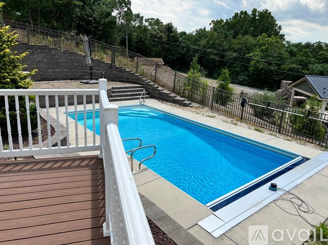 A small pool with a white fence around it.