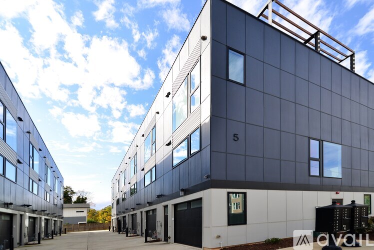 A modern building with a blue sky and clouds in the background.