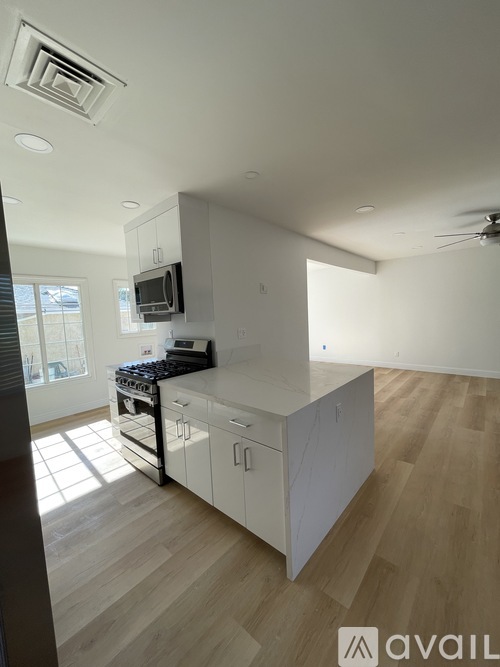 A kitchen with a stove top oven and a microwave on the counter.