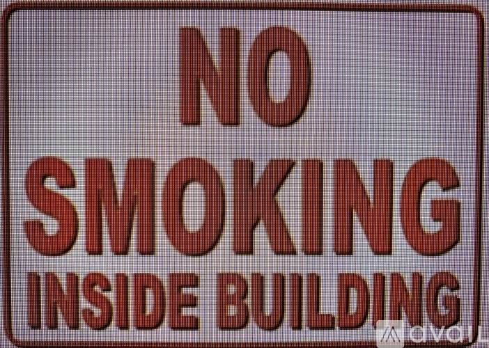 A sign that says no smoking inside the building.