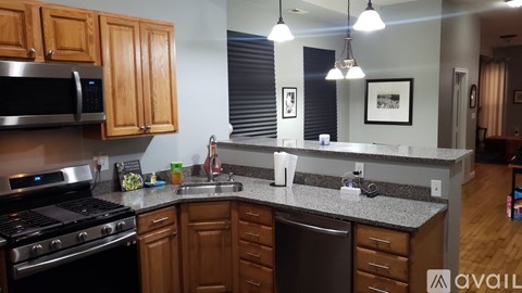 A kitchen with wooden cabinets and granite countertops.