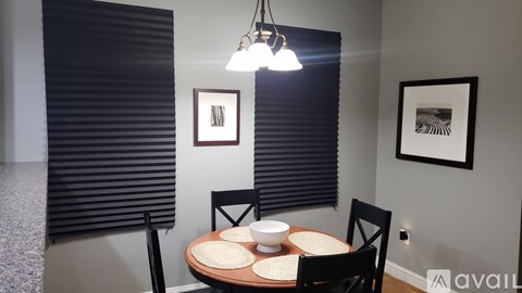 A dining room with a table set for two.