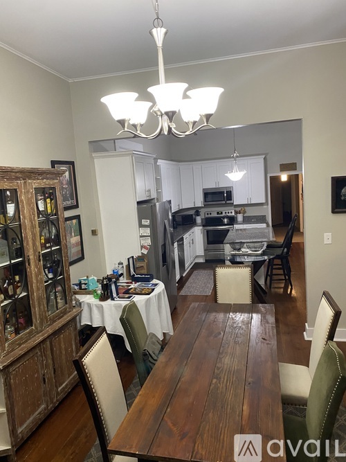 A dining room with a wooden table and chairs.