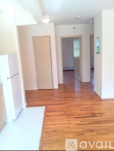 A room with wooden floors and white walls.