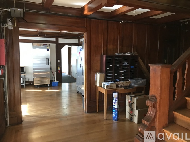 A room with wooden walls and a table with a laptop on it.