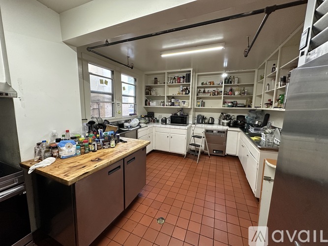 A kitchen with brown cabinets and a wooden counter top.