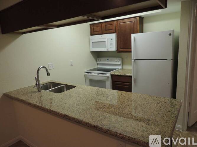 A kitchen with granite countertops and stainless steel appliances.
