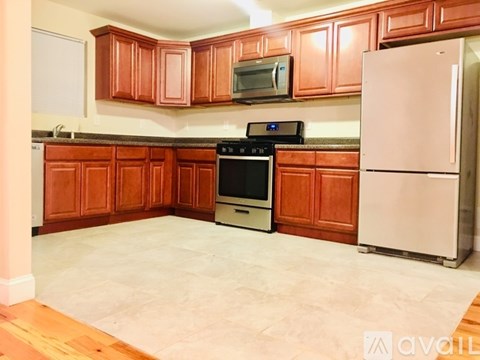 A kitchen with wooden cabinets and a white refrigerator.