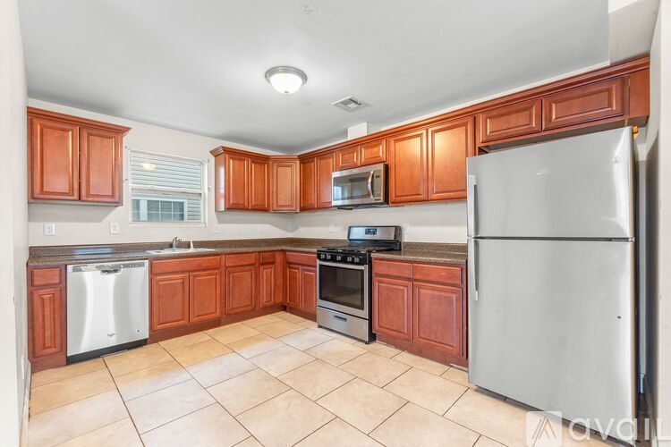 A kitchen with a stove, microwave, and refrigerator.