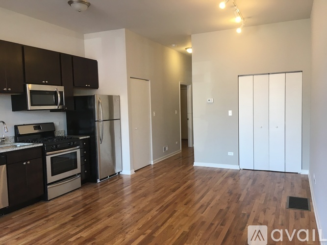 A kitchen with black cabinets and stainless steel appliances.