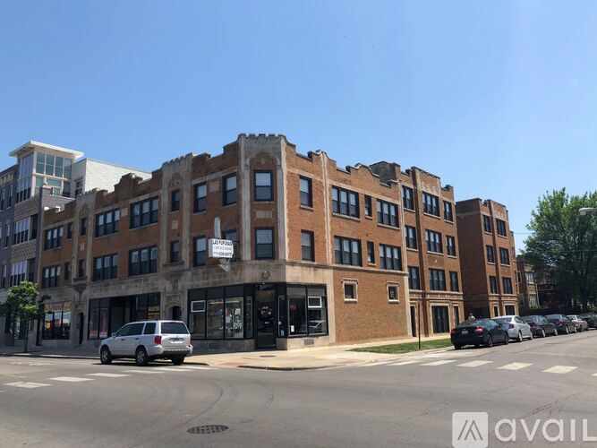 A street view of a building with a car parked in front.