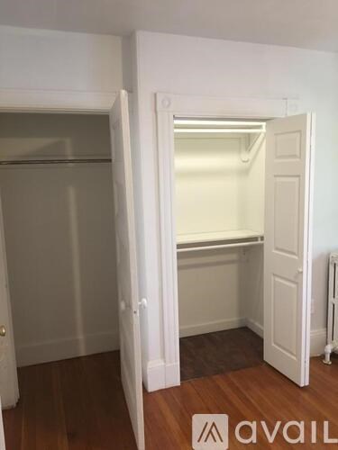 A room with a white door and a white wall.