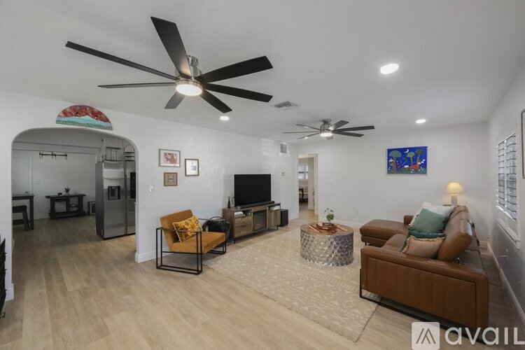 A living room with a brown couch and a television.