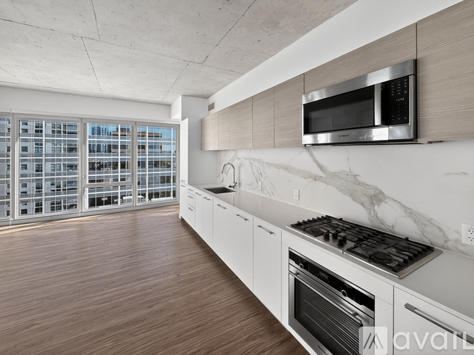 A modern kitchen with a stainless steel microwave above the stove.
