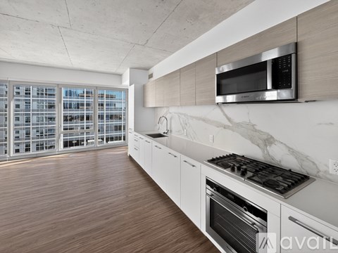 A modern kitchen with a stainless steel microwave above the stove.