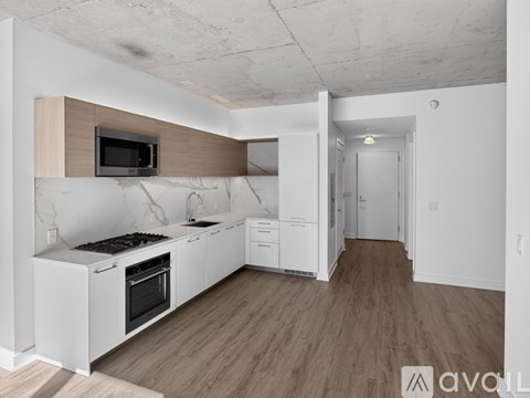A kitchen with white cabinets and a wooden countertop.