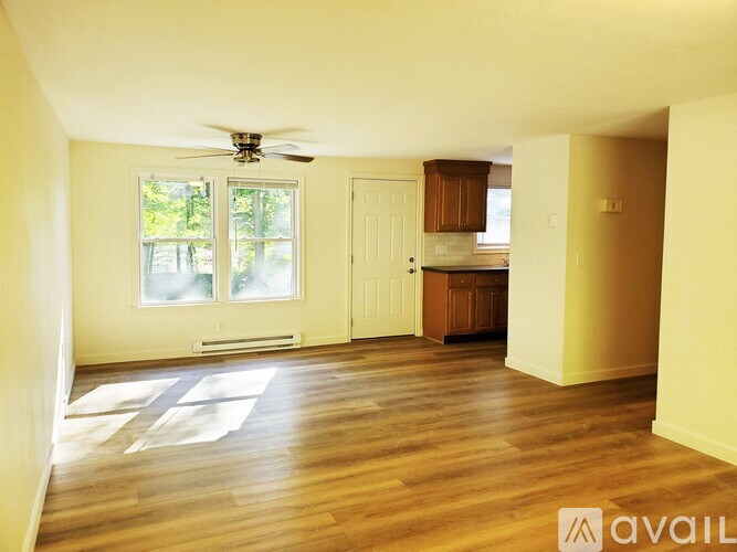 A room with wooden floors and a ceiling fan.