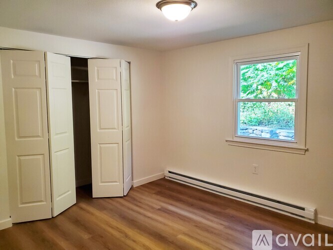 A room with a window and a door.