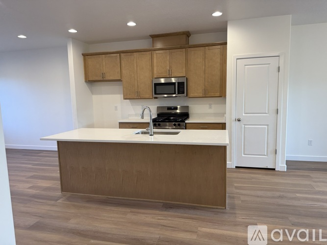 A kitchen with wooden cabinets and a white countertop.