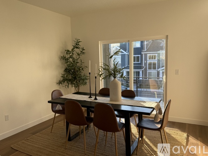 A dining room with a table and chairs.