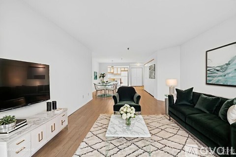 A living room with a green couch and a television.