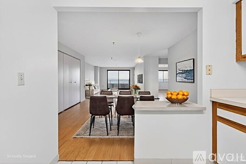 A modern kitchen with a dining table set for two.