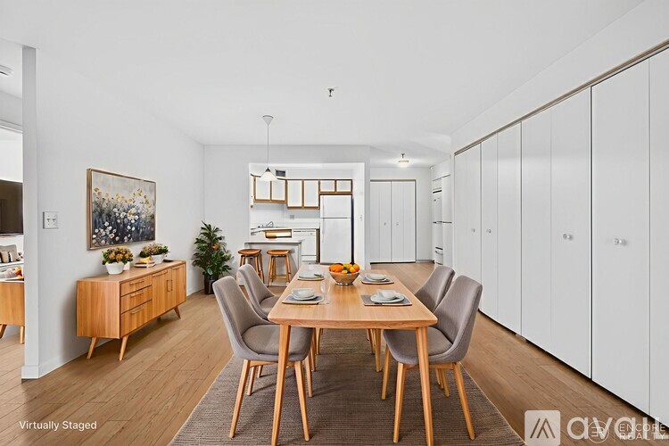 A dining room with a wooden table and chairs.