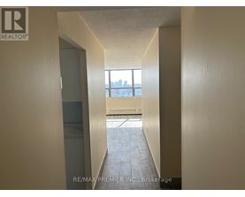 A hallway with a window that has a view of a city.