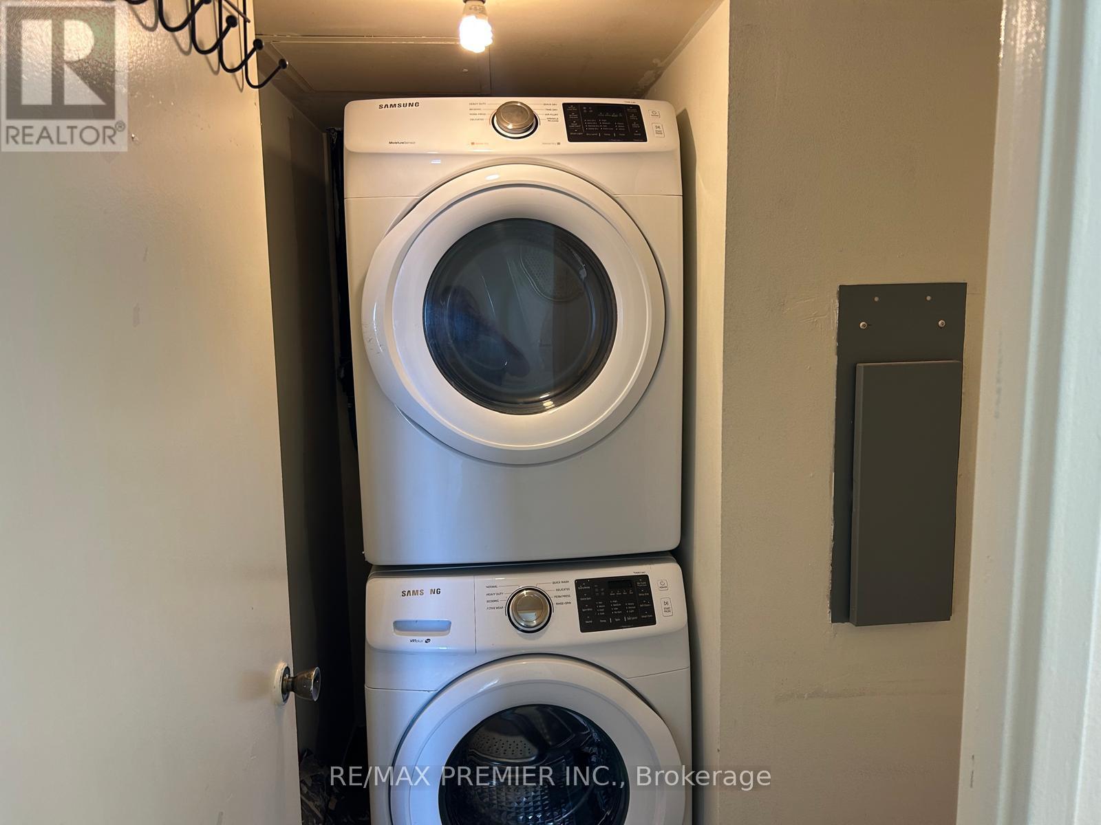 A stack of two washing machines in a small space.