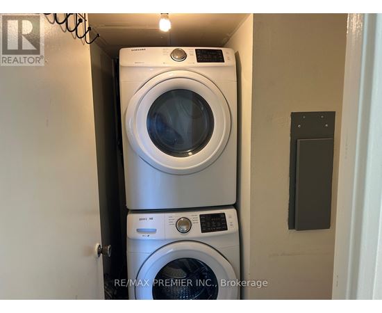 A stack of two washing machines in a small space.