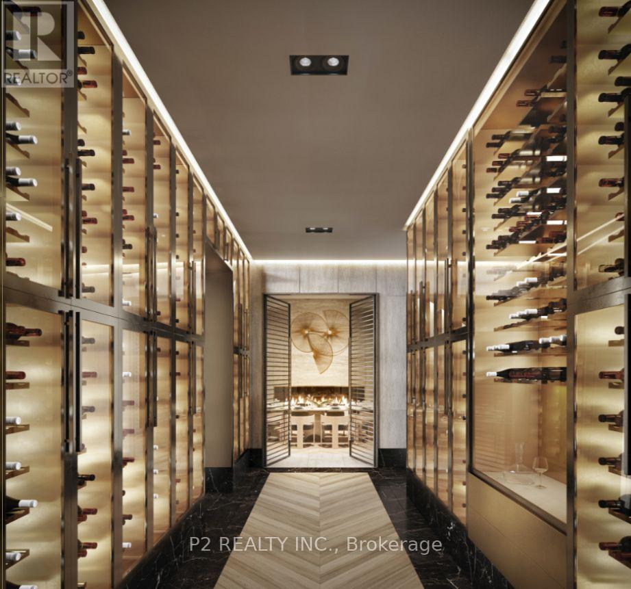 A wine cellar with racks of wine bottles on both sides and a table in the middle.