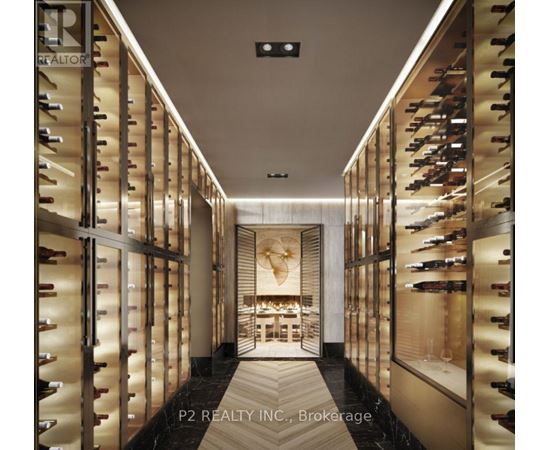A wine cellar with racks of wine bottles on both sides and a table in the middle.