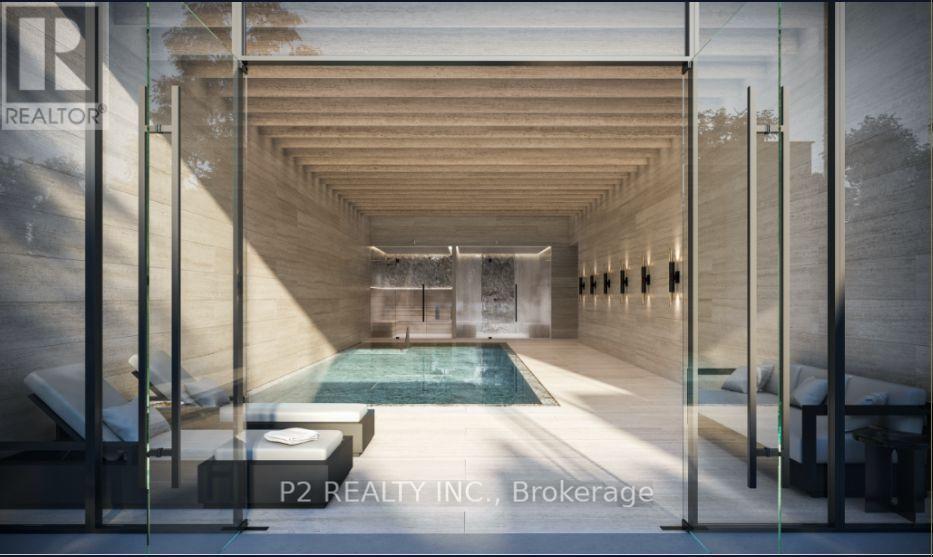 A modern indoor swimming pool with a glass wall on one side.