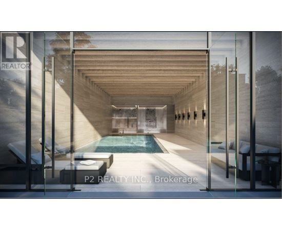A modern indoor swimming pool with a glass wall on one side.