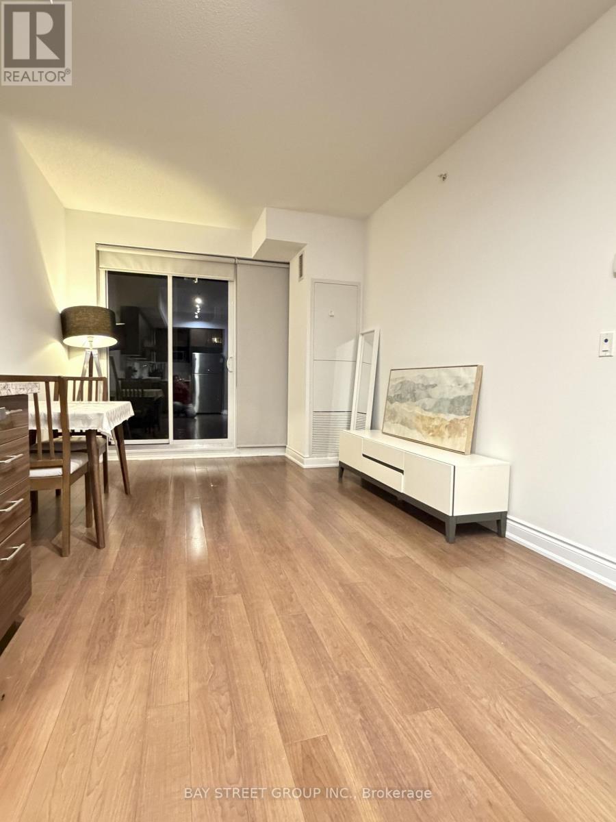 A room with wooden floors and a white cabinet.