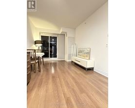 A room with wooden floors and a white cabinet.
