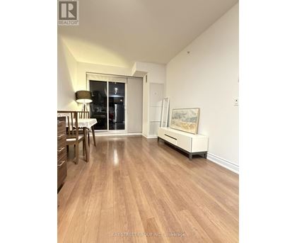 A room with wooden floors and a white cabinet.