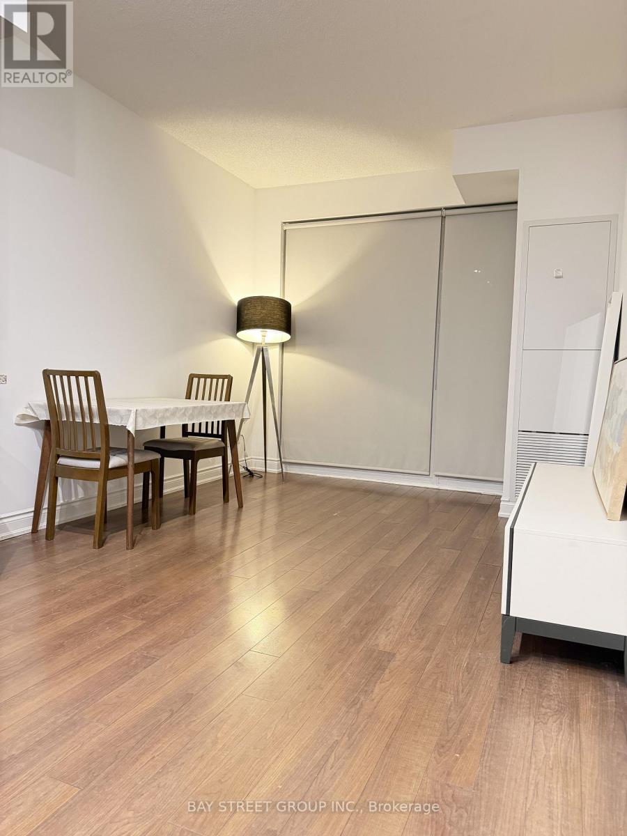 A room with a table and chairs and a lamp.