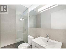 A bathroom with a sink, toilet, and shower.