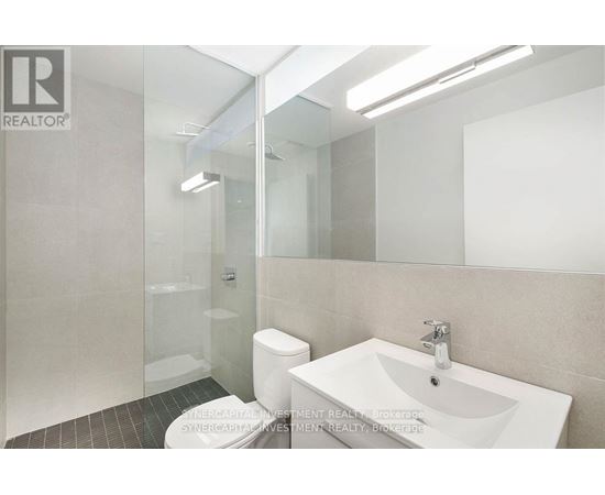 A bathroom with a sink, toilet, and shower.