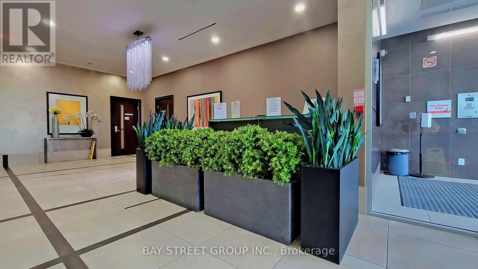 A reception area with a plant in a planter.