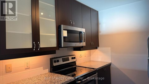 A kitchen with a microwave and stove top oven.