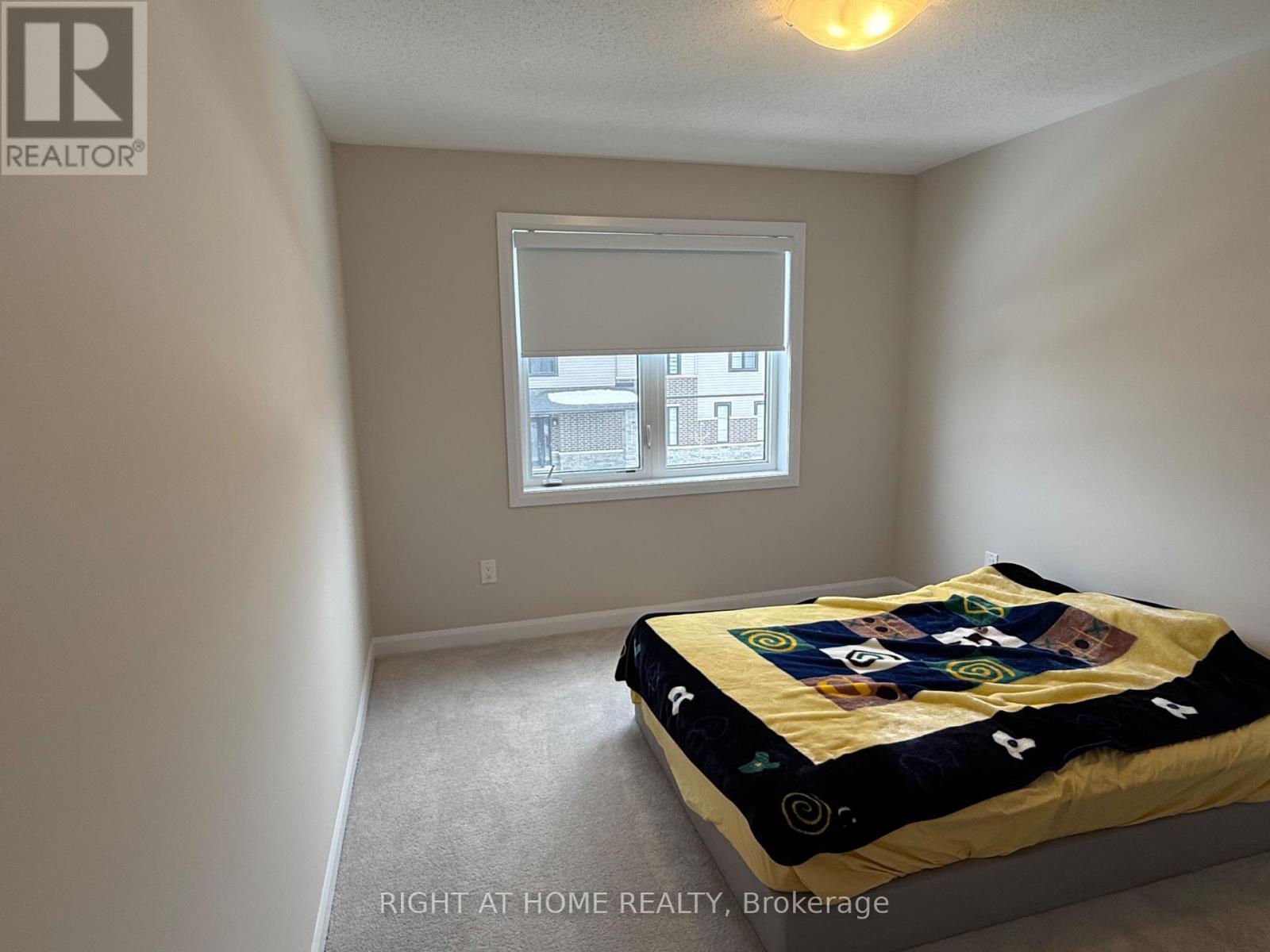A bedroom with a bed and a window.