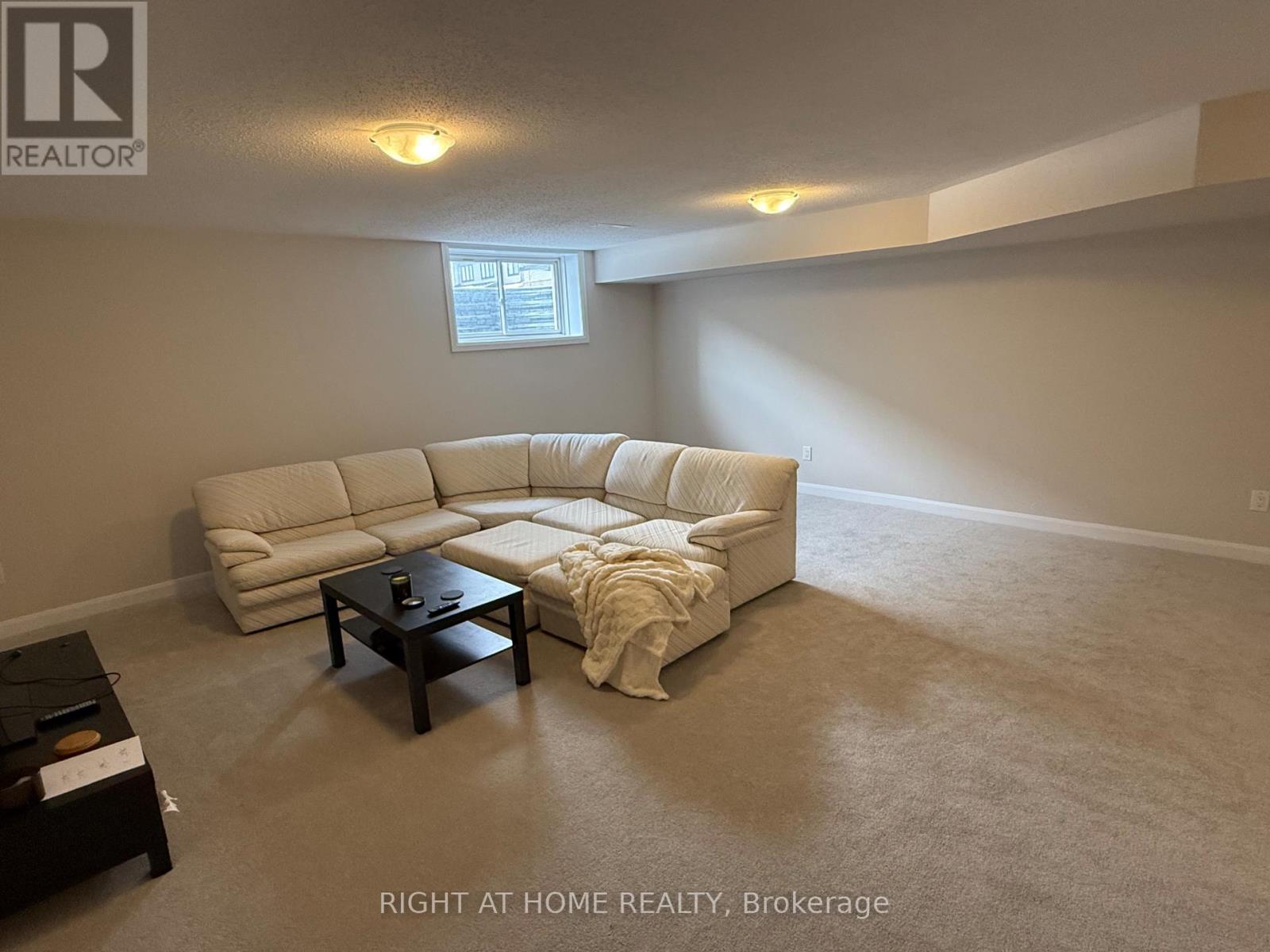 A living room with a white couch and a coffee table.