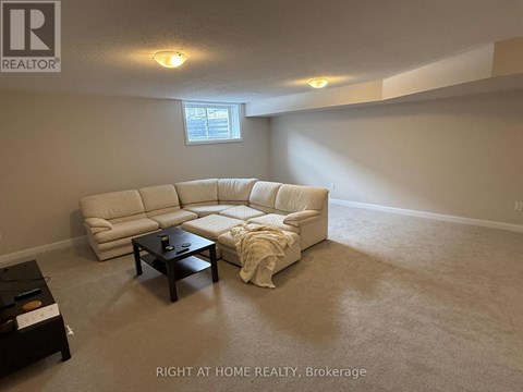 A living room with a white couch and a coffee table.