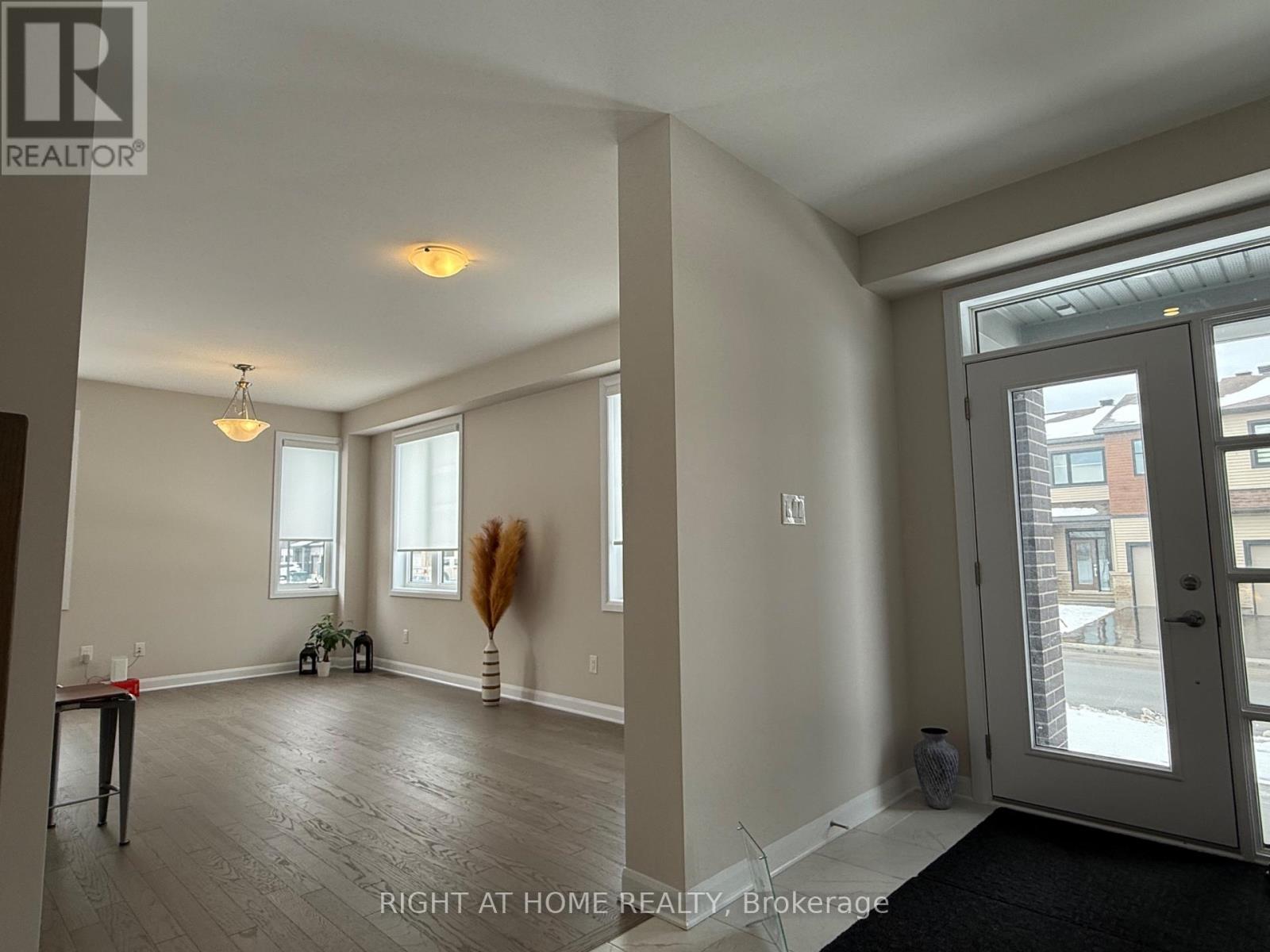 A spacious room with a door leading to a balcony.