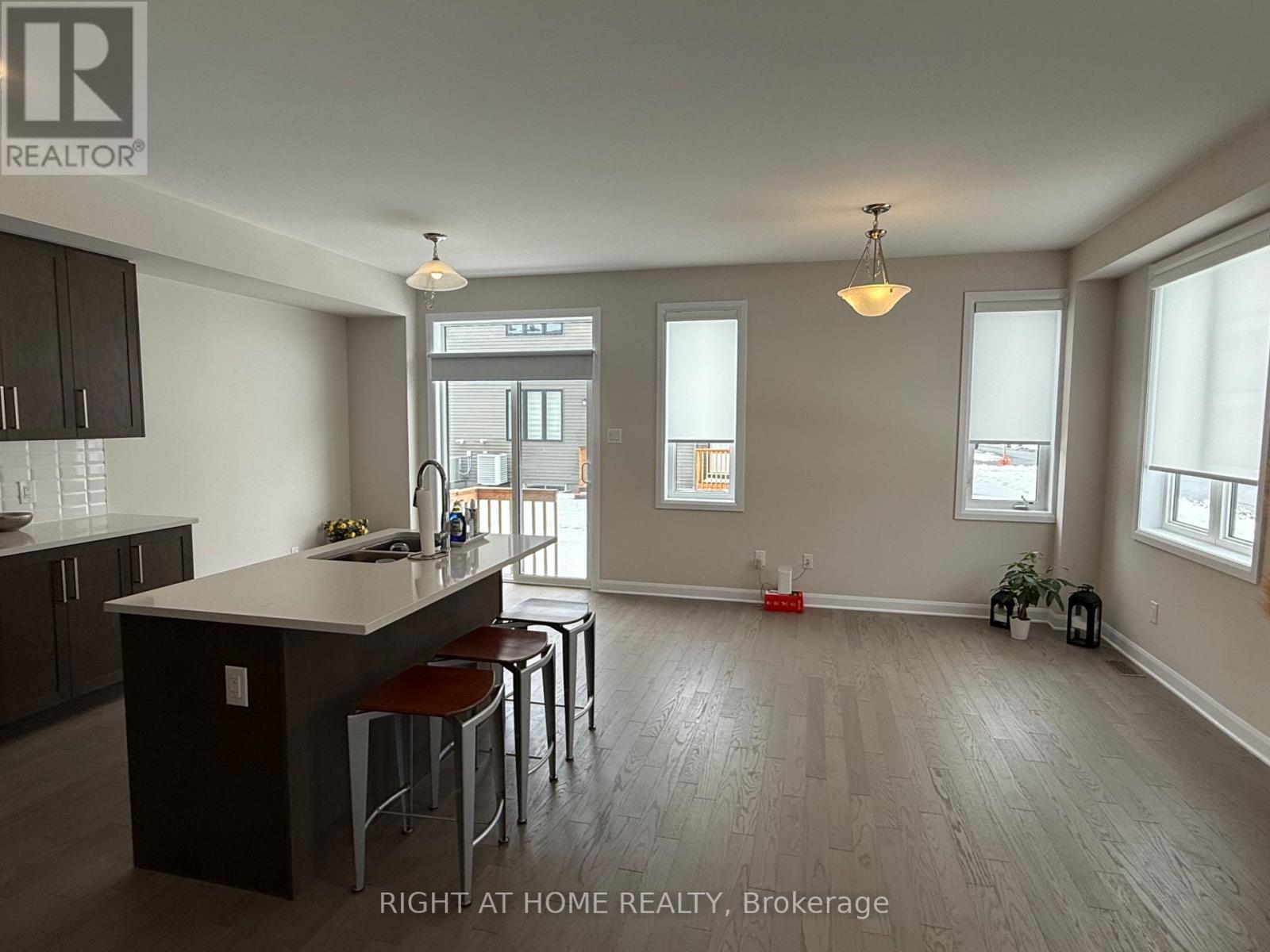A kitchen with a bar stool and a counter.